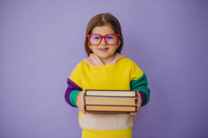 Cute Little Girl Holding Books